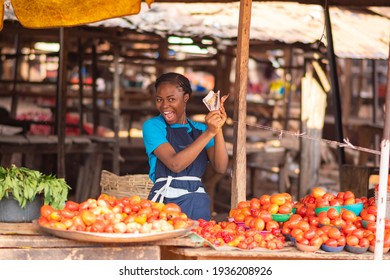 African Market Woman Holding Money Excitedly And Happy Like She Won A Prize