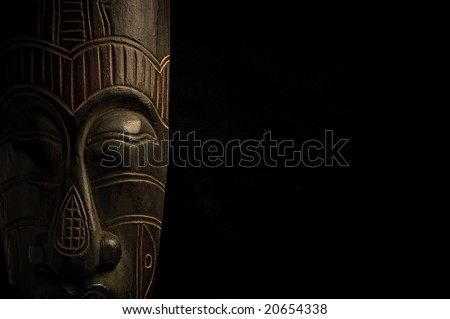 African mask over black background with copy space