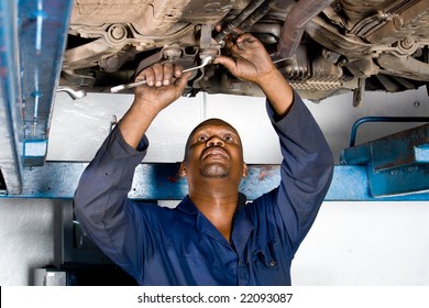 African Mechanic Working On A Broken Down Vehicle