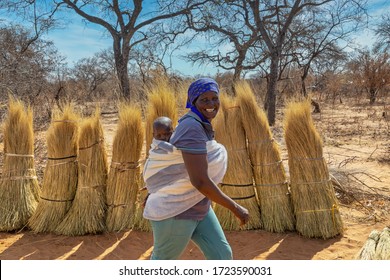 African Mother Carry Child In The Back In A Rural Area In Her Village In Botswana