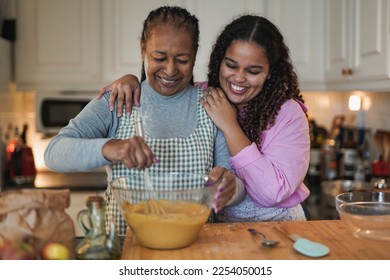 African mother and daughter cooking together at home - Powered by Shutterstock