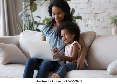 African Mother Daughter Spend Time With Laptop, Parent Teach Child Use Computer, Buying On-line Via Web Store, Enjoy Distance Shopping. Young Generation And Modern Tech, Family Leisure At Home Concept