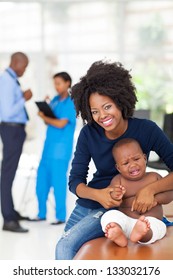 African Mother And Her Sick Baby Boy Waiting For Checkup In Doctor's Room