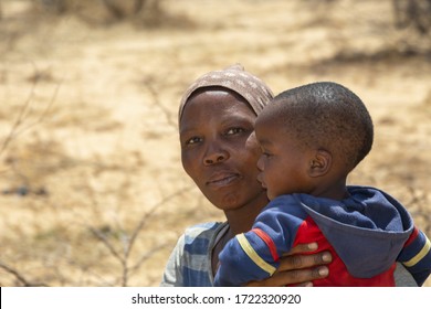 African Mother Holding Her Toddler Baby In Her Arms, Botswana Rural Village