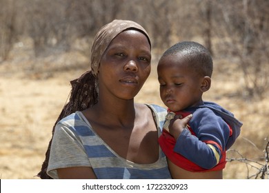 African Mother Holding Her Toddler Baby In Her Arms, Botswana Rural Village