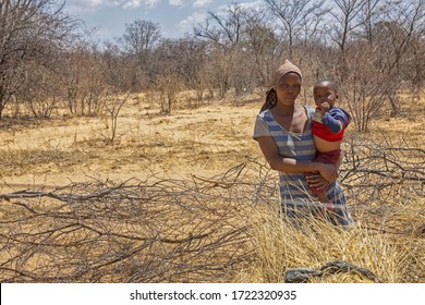 African Mother Holding Her Toddler Baby In Her Arms, Botswana Rural Village