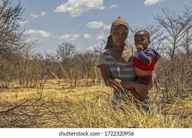 African Mother Holding Her Toddler Baby In Her Arms, Botswana Rural Village