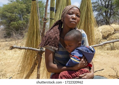 African Mother Holding Her Toddler Baby In Her Arms, Botswana Rural Village