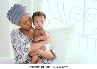 African Mother Raising A Happy Baby In The House