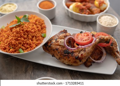 African National Dish Grilled Chicken With Plantain And Bananas And Fresh Salad. Healthy Lifestyle Eating. Nigerian Meal With Jollof Rice. Jolof Rice With Fish Curry. Grilled Fish Curry With Egg