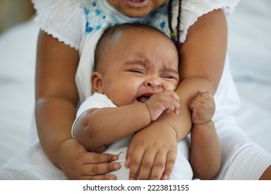 African Newborn Baby Crying And Her Sister Soothing To Stop Crying On Bed