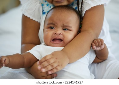 African Newborn Baby Crying And Her Sister Soothing To Stop Crying On Bed