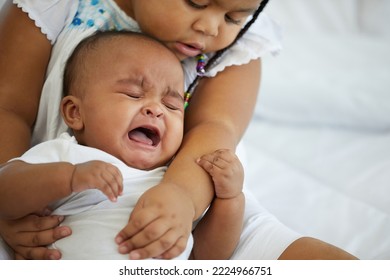 African Newborn Baby Crying And Her Sister Soothing To Stop Crying On Bed