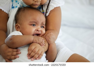 African Newborn Baby Crying And Her Sister Soothing To Stop Crying On Bed