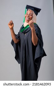 African Nigerian Muslim Lady, Student Or Graduand In Hijab And Graduation Gown Celebrates Her Success In Education A