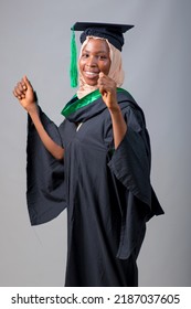 African Nigerian Muslim Lady, Student Or Graduand In Hijab And Graduation Gown Celebrates Her Success In Education 