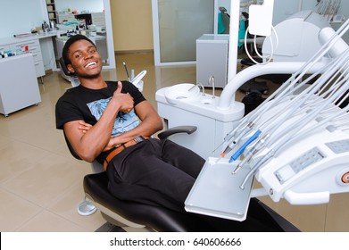 African Patient In Dentistry Smiling In Dental Chair