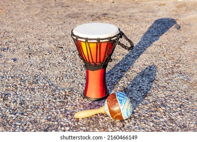 African percussion instrument djembe and marocas on the sand near the ocean. National African and Latin American exotic percussion instruments at the carnival for creating rhythm, dancing, meditation
