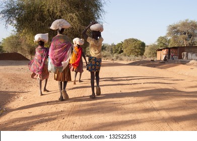 African Pokot Girls Leave The Market In Amudat, Karamoja, Carrying Bags With Food. Uganda, Africa.