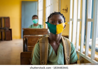 African Primary School Pupil's Sitting In Class, Wearing Face Masks, And Observing Physical Distancing