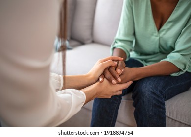 African psychologist hold hands of girl patient, close up. Teenage overcome break up, unrequited love. Abortion decision. Psychological therapy, survive personal crisis, individual counselling concept - Shutterstock ID 1918894754