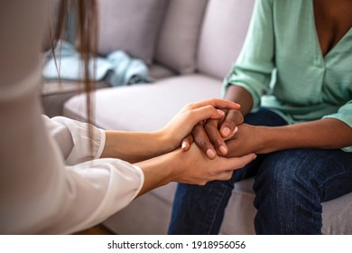 African psychologist hold hands of girl patient, close up. Teenage overcome break up, unrequited love. Abortion decision. Psychological therapy, survive personal crisis, individual counselling concept - Shutterstock ID 1918956056