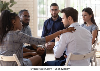 African psychologist supporting male rehab session participant put hand on newcomer shoulder talks encouraging words, medical detox center, psychological help activity struggle with addictions concept