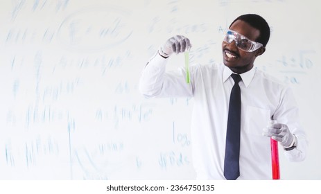 African scientists are conducting experiments on chemicals for medical use while wearing safety gloves and goggles. - Shutterstock ID 2364750135