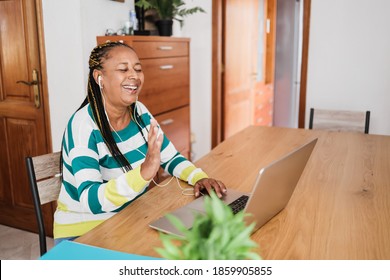 African Senior Woman Doing Video Call During Coronavirus Lockdown - Old Person Having Fun With Technology Trends - Social Distance Concept - Focus On Face