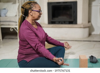 African Senior Woman Doing Yoga Meditation At Home - Healthy Lifestyle And Balance Concept