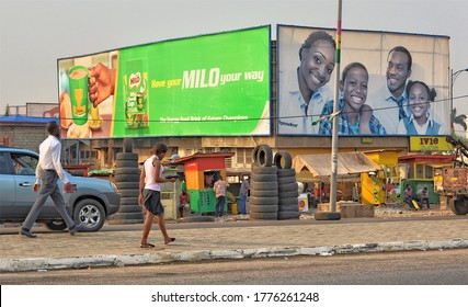 African Street With People, Tire Sale, Vendors, Billboards, Advertisement, Cars. City Life In West Africa. Lifestyle. Urban Landscape. Ghana, Accra – January 27, 2017   
