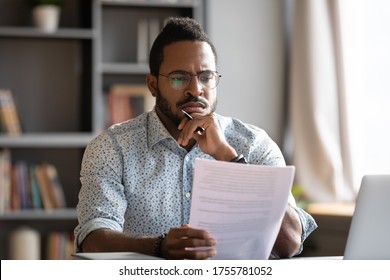 African Student Guy Sit At Desk Hold Papers Tasks Having Difficulties With Test, Company Lawyer Read Contract Terms And Detail Feels Discontented, Received Bad News From Bank Unpleasant Letter Concept