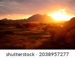 African sunset with mountains and grass plains