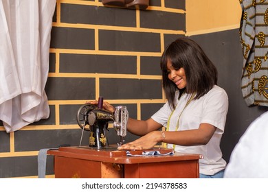 African Tailor Working In Her Shop