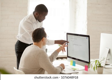 African Team Leader Helping Colleague With Computer Work Explaining Coworker New Corporate Application Usage, Black Mentor Teaching Intern Supervising And Giving Instructions About Emails In Office