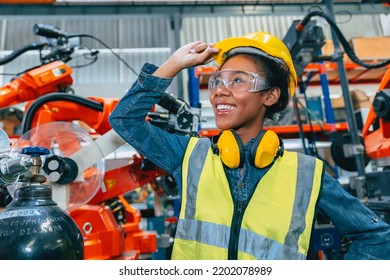 African Teen Young Smart Women Engineer Worker Working In Advanced Robotic Factory With Safety