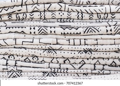 African Textiles At A Market Stall Featuring Black And White Patterns On Hand-woven Cloth By A Woman From Ghana