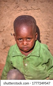 African Toddler Sitting Down In His Yard, Village Life Botswana