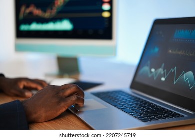 African Trader Studying Stock Market At Home - Focus On Right Hand