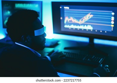 African trader working inside office at night time wearing virtual reality headset - Trading and technology concept - Soft focus on glasses - Powered by Shutterstock