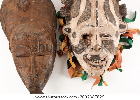An African tribal mask figure, hand carved from wood. Isolated on white.
