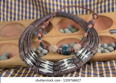 African tribal necklace with background made of African artifacts, private collection, Belgrade, 15. March 2019