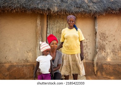 African Village Family Three Generations In Front Of The House With The Thatched Roof