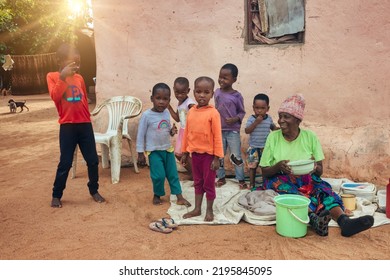 African Villagers Granny With Grandchildren Standing In The Yard