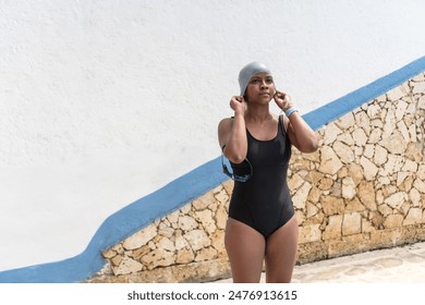 African Woman Adjusting Swim Cap by the Pool - Powered by Shutterstock