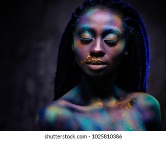 African woman with coloufrul powder on her face. - Powered by Shutterstock