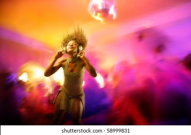 African woman dancing to the music in a disco