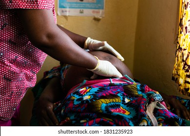 African woman doctor examining a pregnant patient