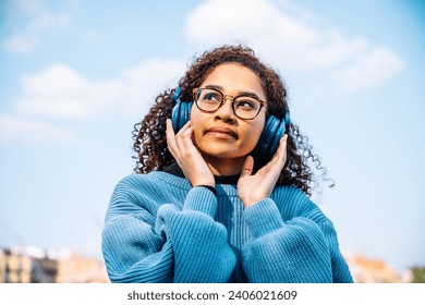 African woman Enjoying Music in the Park - Powered by Shutterstock