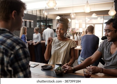 African woman entrepreneur having a meeting in coffee shop  - Shutterstock ID 387399184